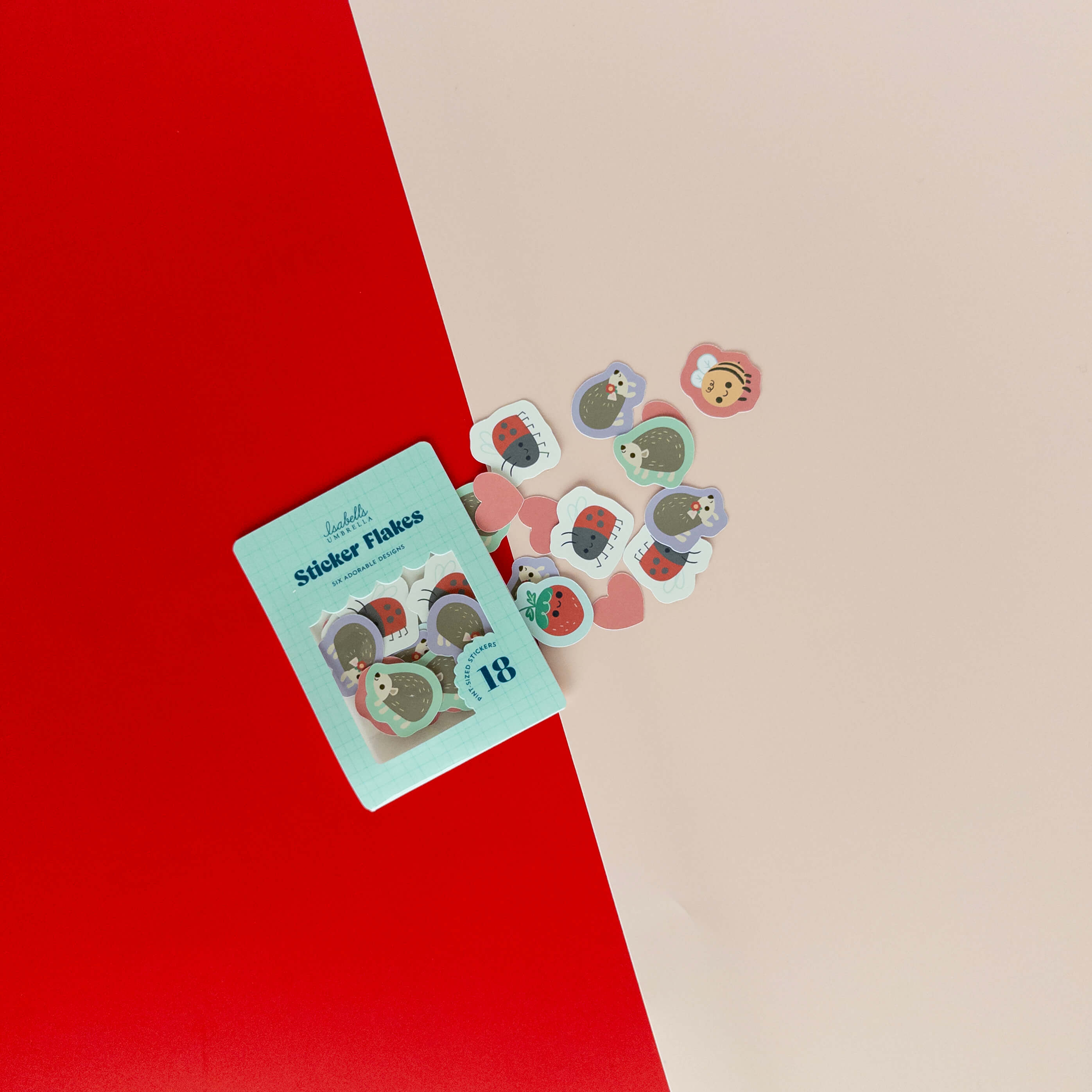 Cute hedgehog sticker flakes scattered around their packaging on a red and cream background.