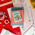 Pack of cute roly poly sticker flakes displayed on colorful notebooks and stationery.