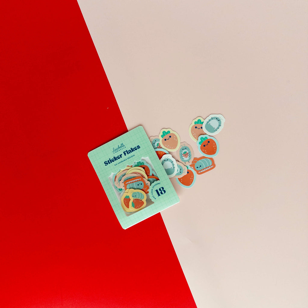 Cute roly poly sticker flakes scattered around their packaging on a red and cream background.