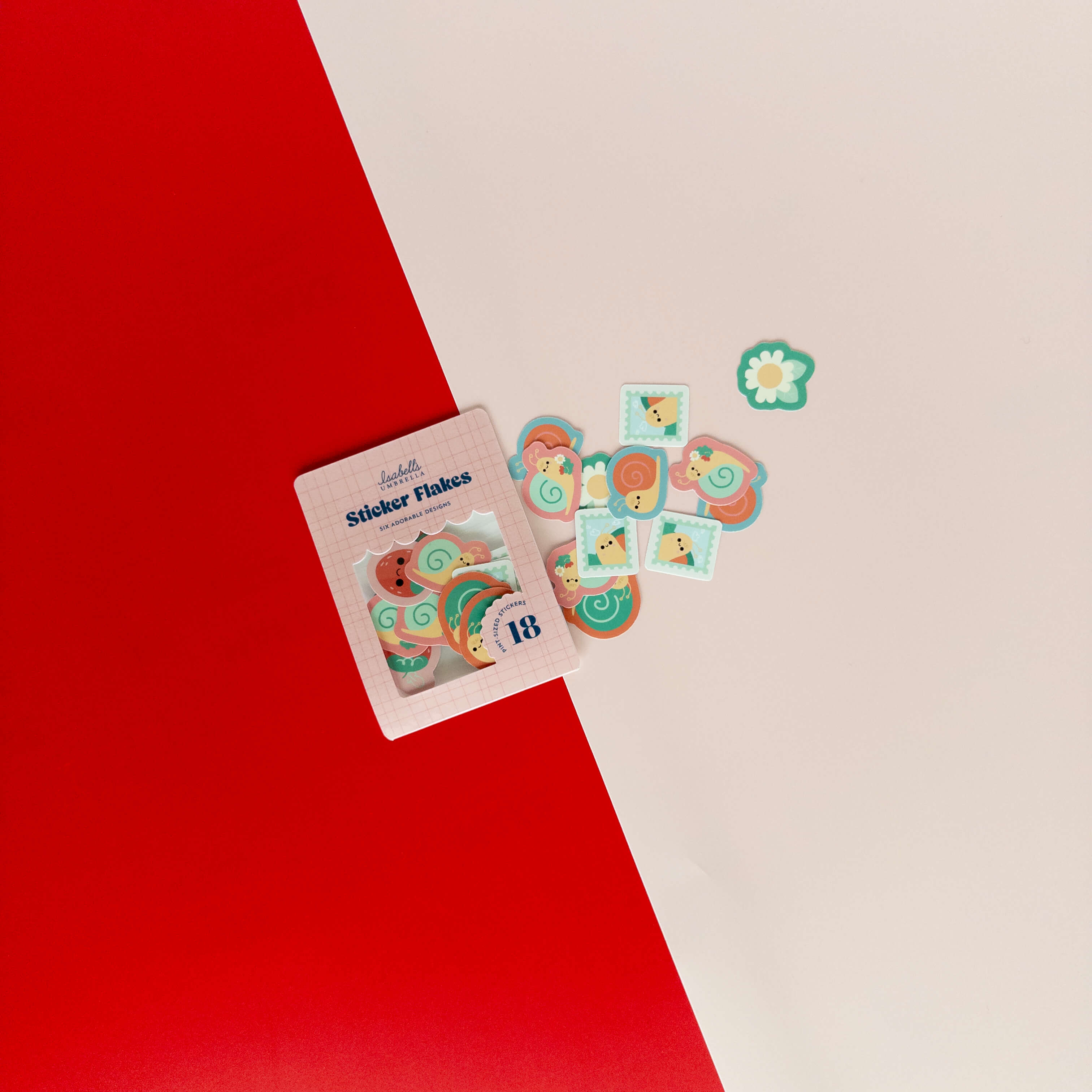 Cute snail sticker flakes scattered around their packaging on a red and cream background.