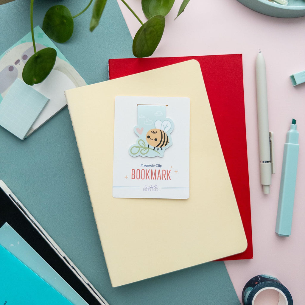 Bee with plant magnetic bookmark displayed on branded backer card, soft matte finish, perfect gift for readers and plant enthusiasts.
