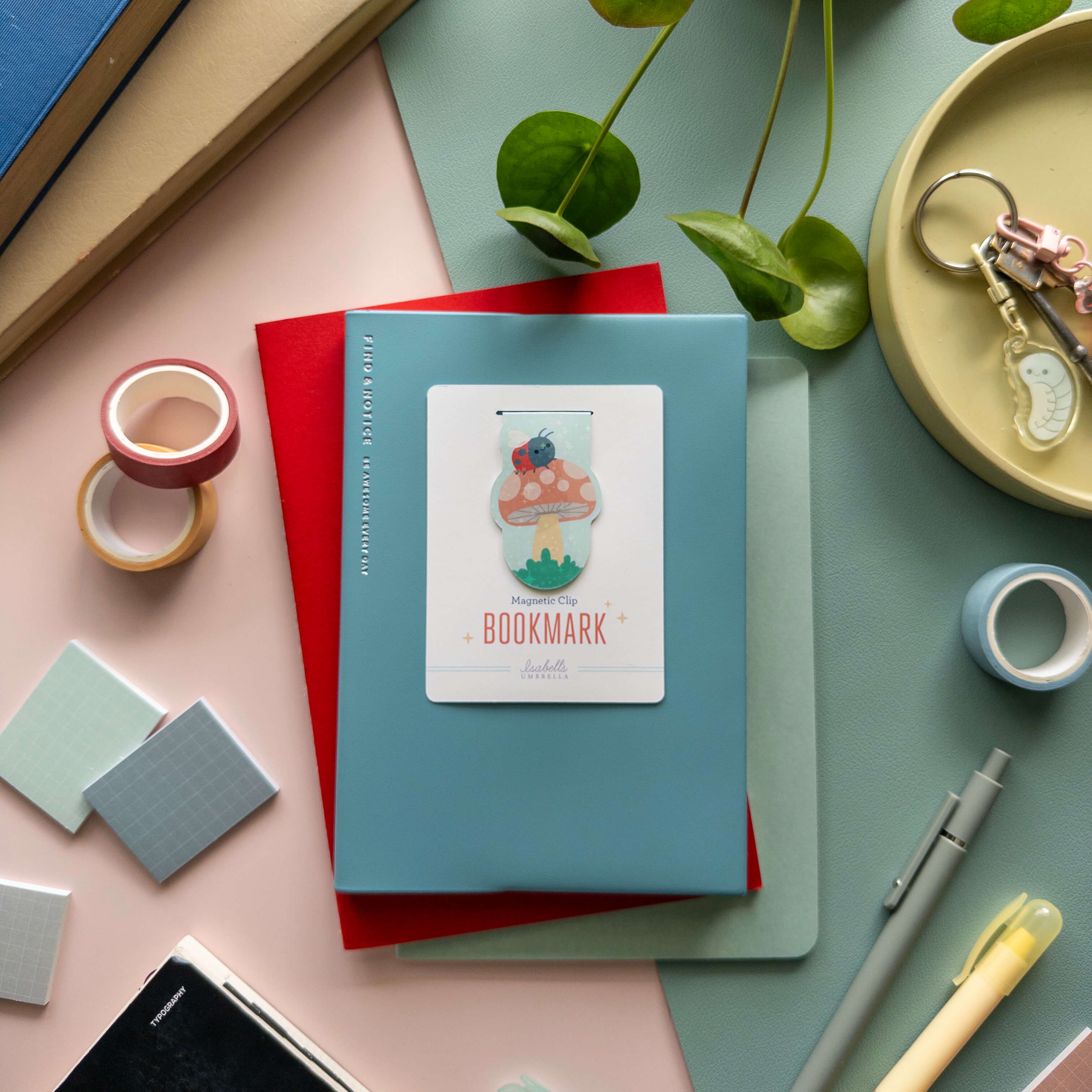 Colorful mushroom-shaped magnetic bookmarks with stationery items on a pastel background