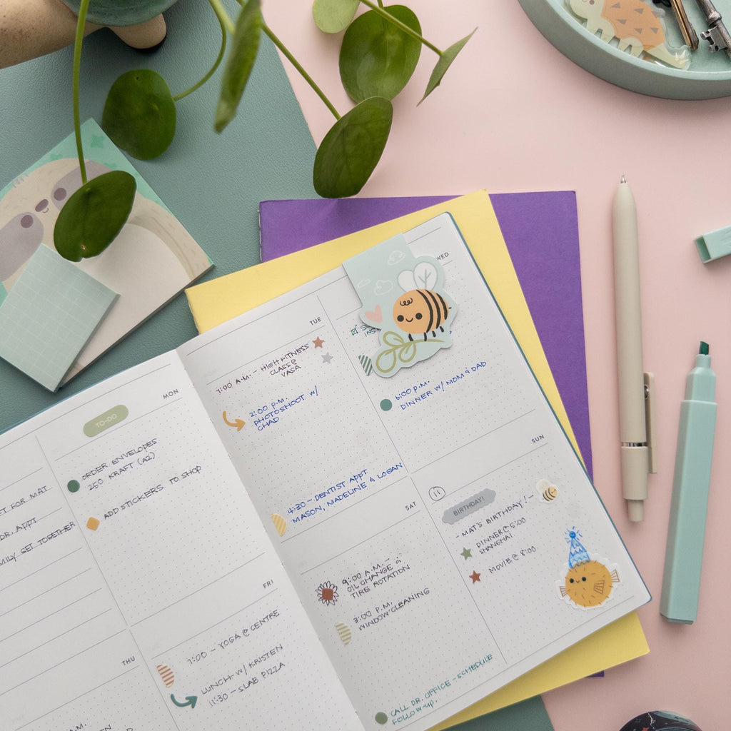 Bee with plant magnetic bookmark clipped onto a book page, cute nature-inspired reading accessory for students and gardeners.