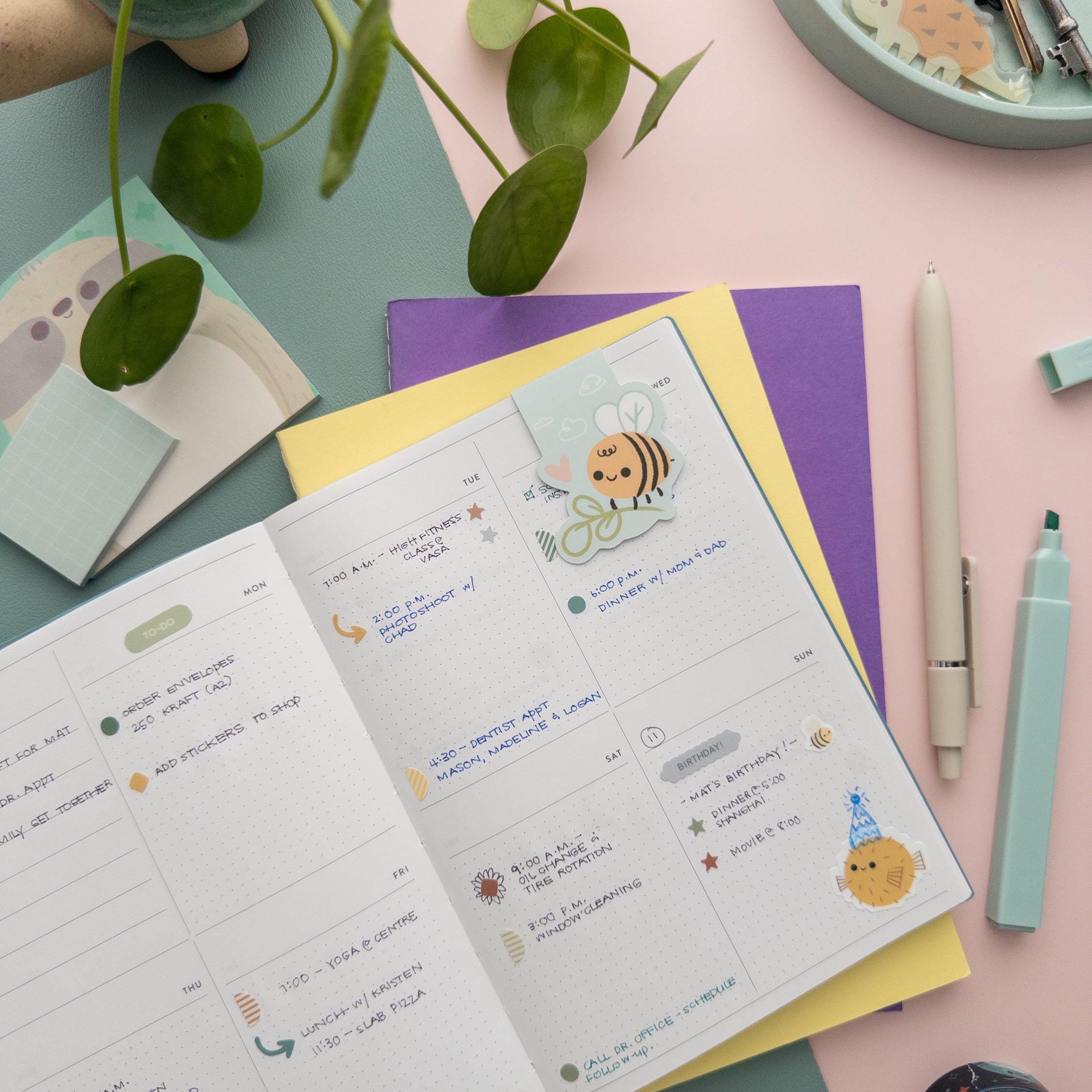 Bee with plant magnetic bookmark clipped onto a book page, cute nature-inspired reading accessory for students and gardeners.