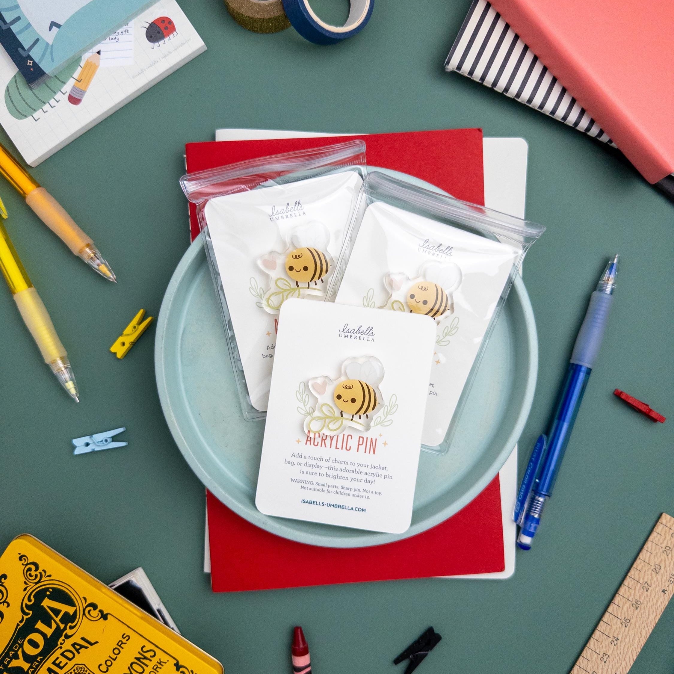 Cute bee with flower acrylic pin featuring glossy epoxy finish, kawaii cottagecore brooch perfect for jackets, totes, and gifts for bee lovers.