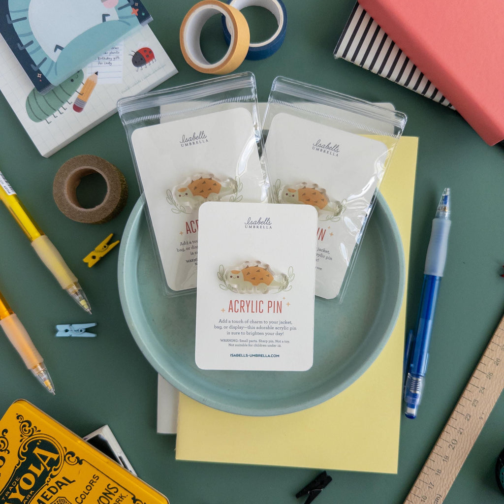 Desk with stationery items including a plate with packaging, pens, and books.