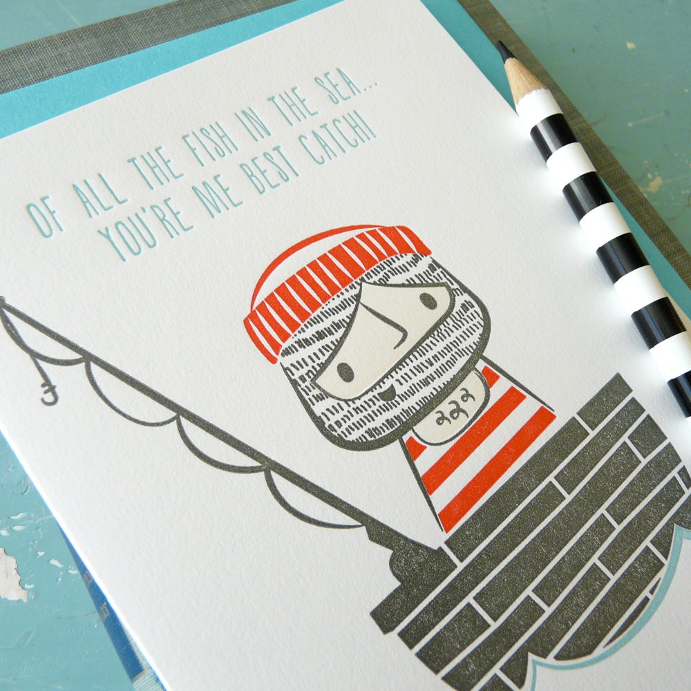 Close up photo of a sailor in a boat letterpress card with the phrase “Of all the fish in the sea, you’re me best catch,” cute nautical anniversary and friendship card