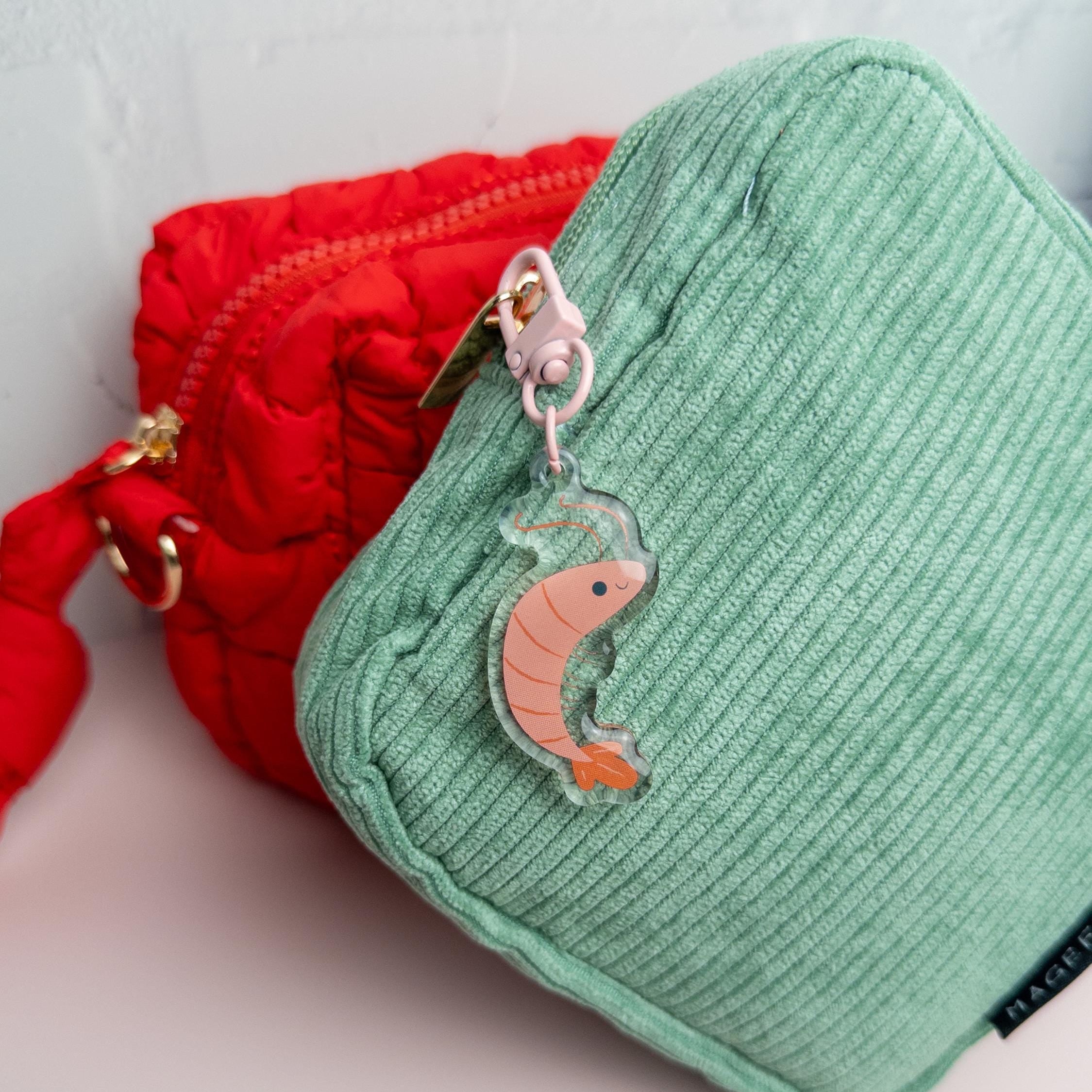 Green textured pouch with a cute shrimp acrylic keychain with glossy epoxy finish attached to its zipper