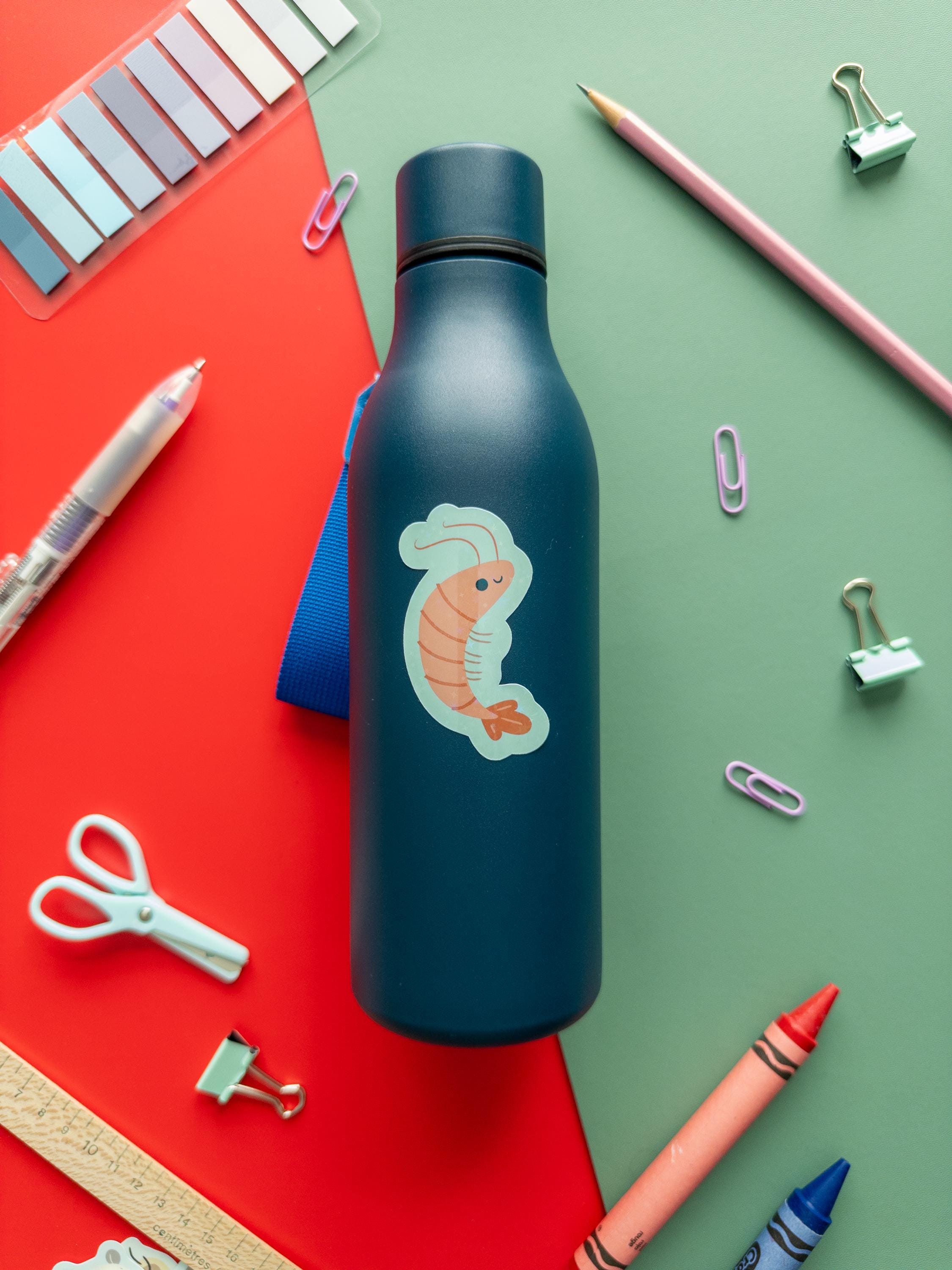 Cute glitter shrimp vinyl sticker with sparkly finish, waterproof and durable sea creature decal for laptops, water bottles, and journals.
