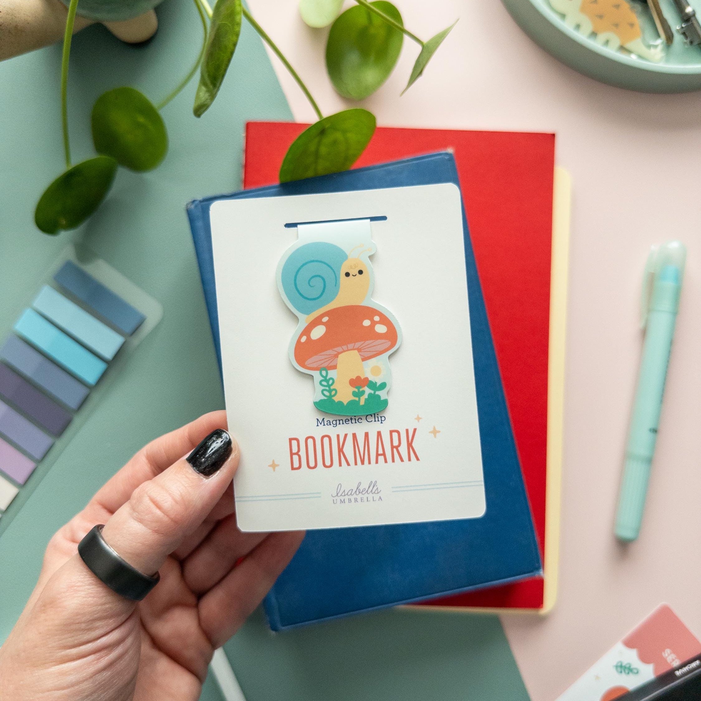 Snail mushroom magnetic bookmark displayed on illustrated backer card, soft-touch laminated finish, perfect gift for readers.
