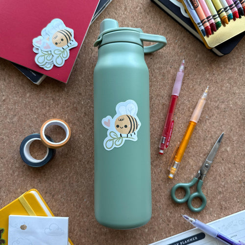 Cute glitter bee vinyl sticker with sparkly finish, waterproof and durable decal for laptops, water bottles, and notebooks.