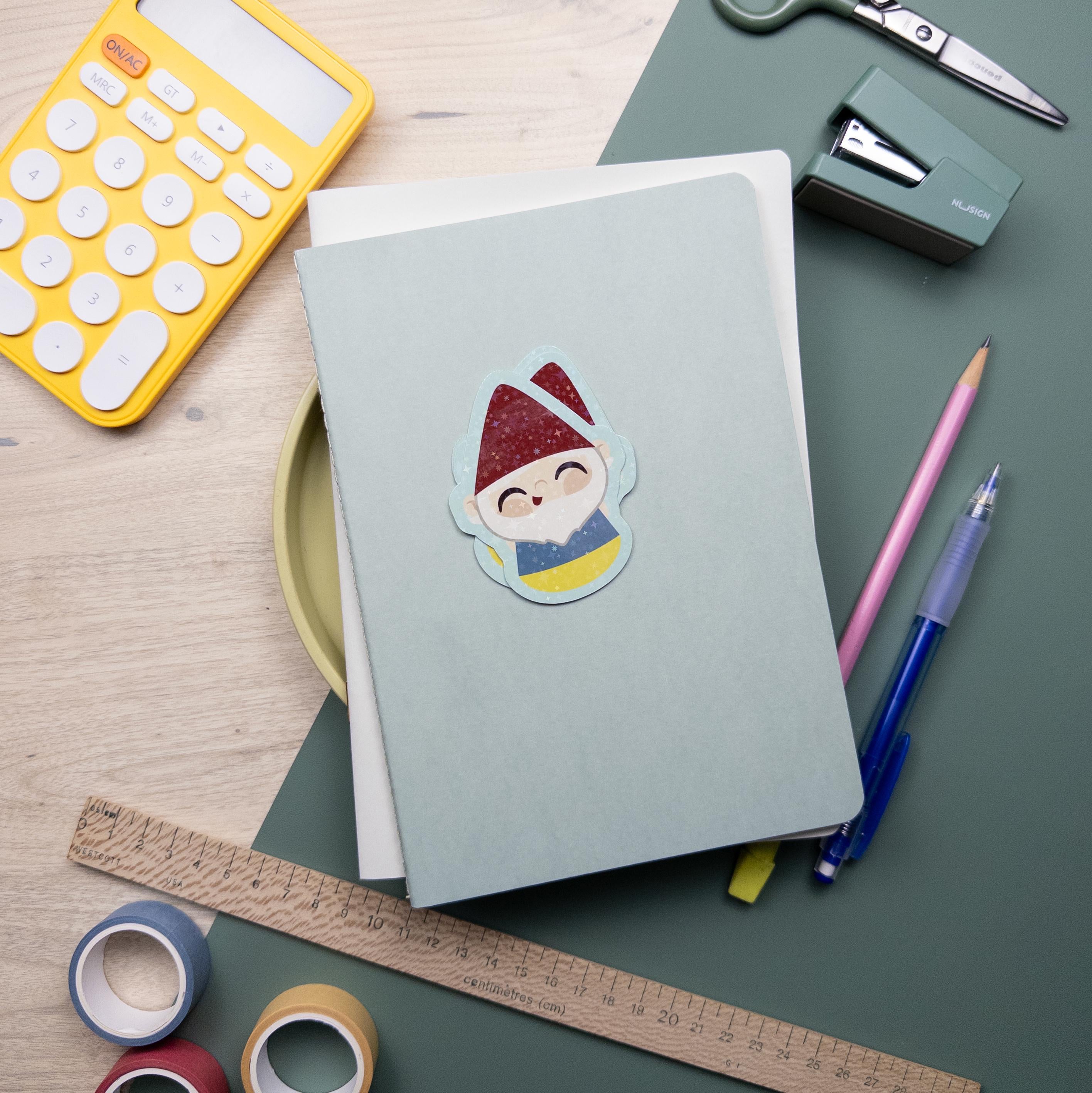 A cute glitter garden gnome vinyl sticker, waterproof and durable kawaii decal for laptops, water bottles, and journals, cottagecore design.