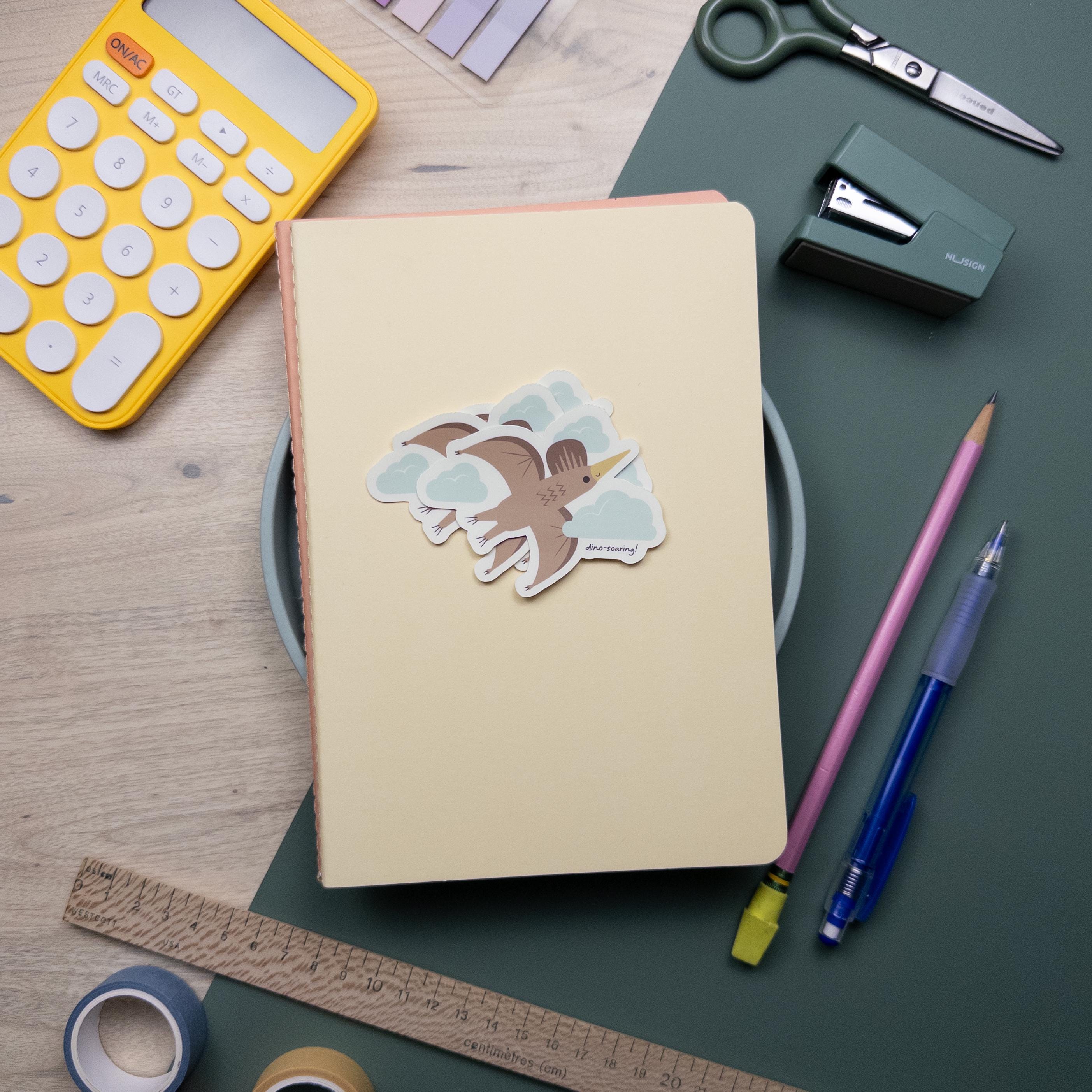 Cute illustrated pterodactyl vinyl sticker, waterproof flying dinosaur decal for laptops, water bottles, and journals, kawaii prehistoric design.