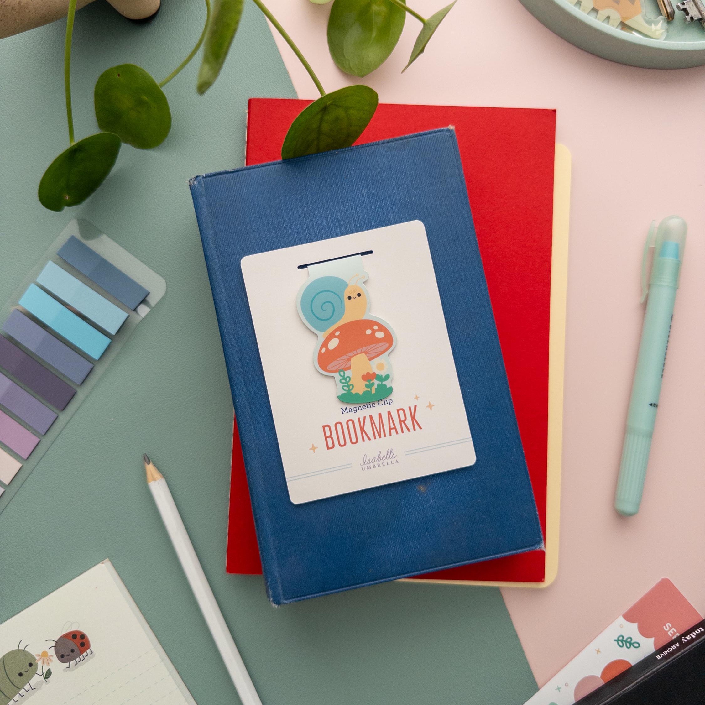 Snail on mushroom magnetic bookmark with matte finish, cute kawaii cottagecore book accessory with branded backer card.