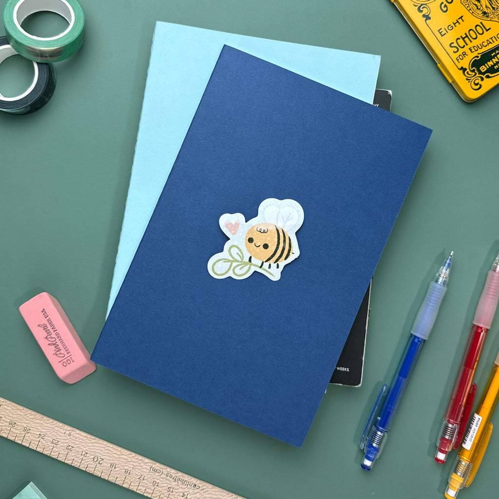 Cute glitter bee vinyl sticker with sparkly finish, waterproof and durable decal for laptops, water bottles, and notebooks.