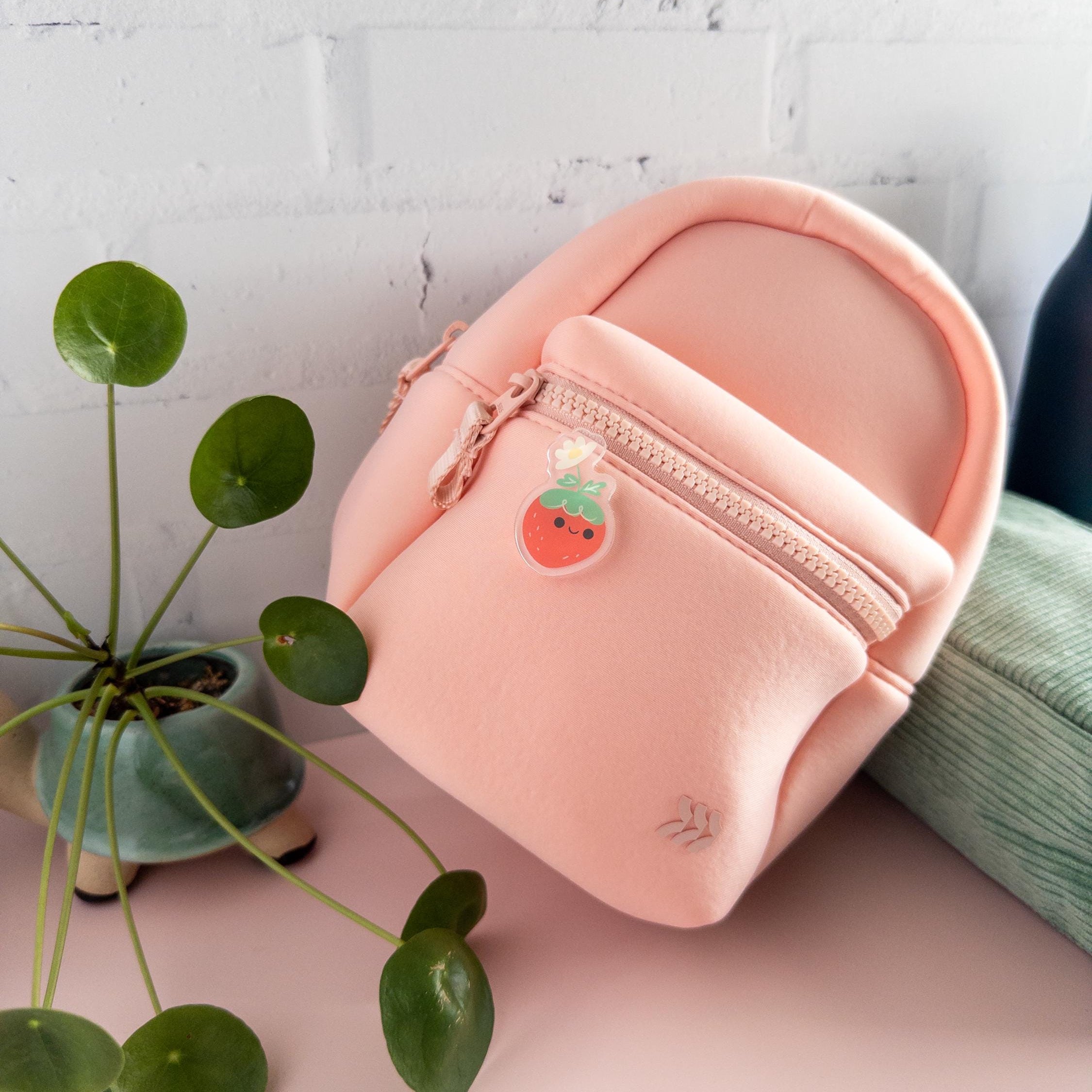 Cute kawaii strawberry acrylic pin with flower detail, glossy epoxy enamel-style brooch for jackets, bags, and cottagecore lovers.